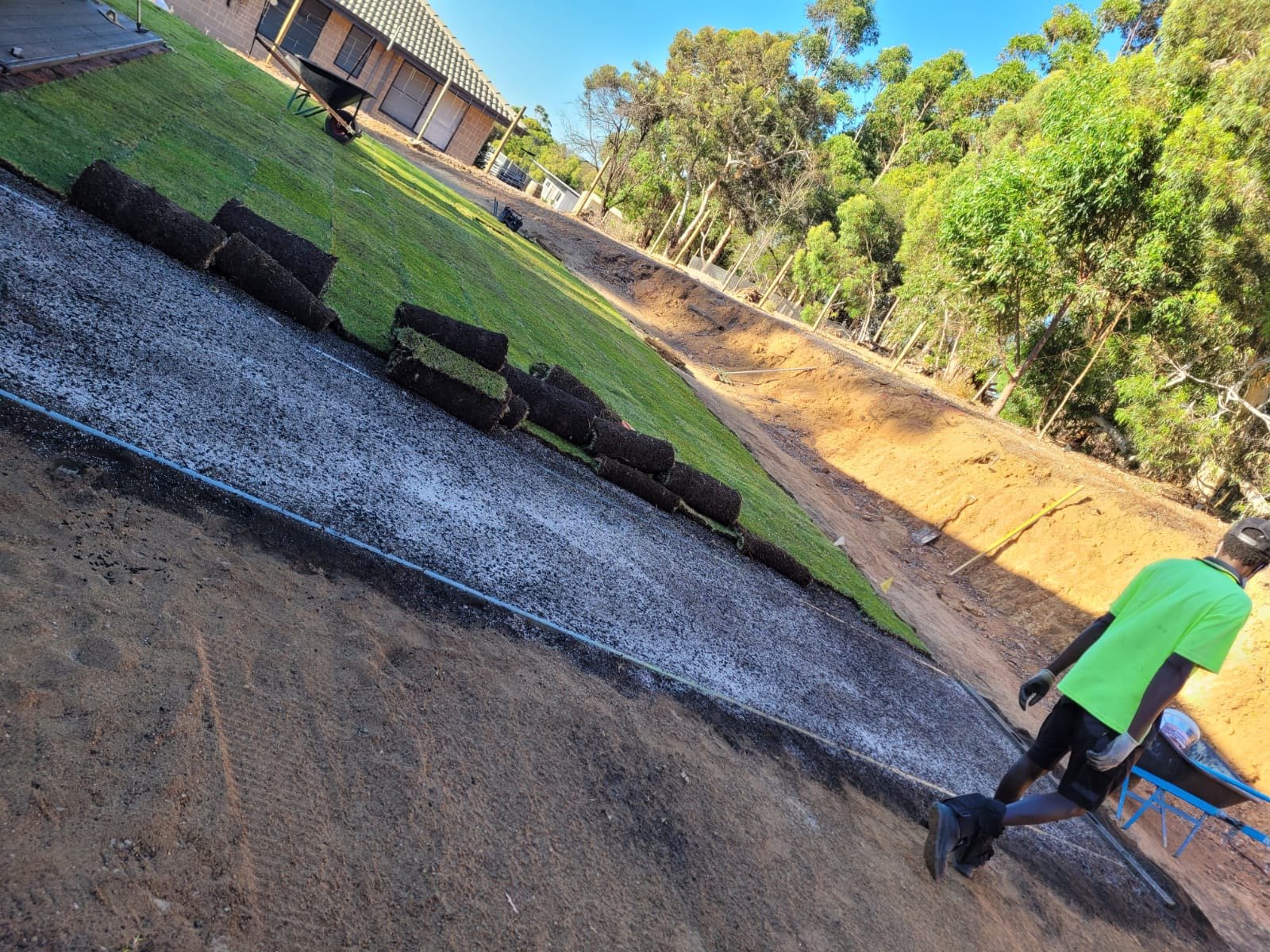 Crew laying fresh turf rolls on a Perth property